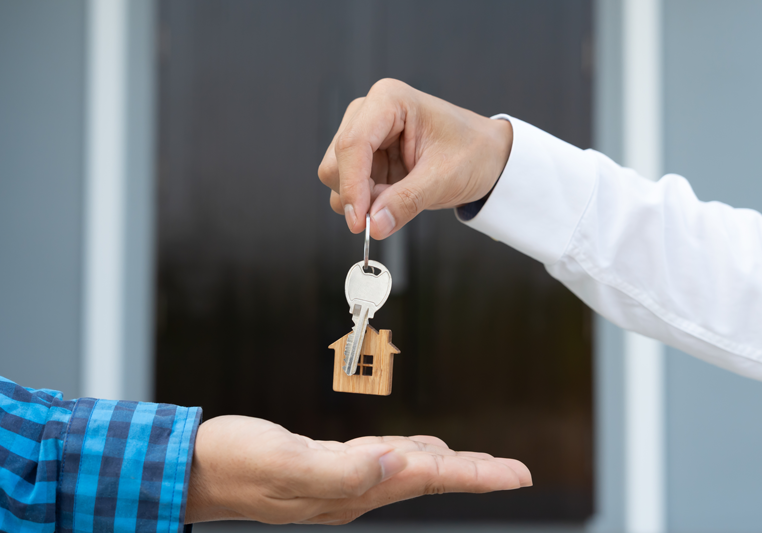 Krogman & Company - Buy/Sell - Man handing another man keys to a home